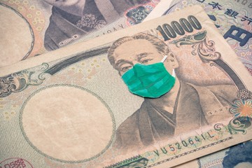 Men wear face mask on Japanese yen bill banknote background. Global novel coronavirus (Covid-19)...