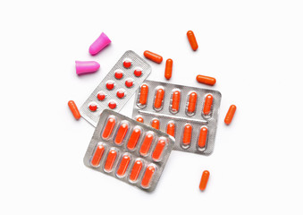 Ear plugs and sleeping pills on white background