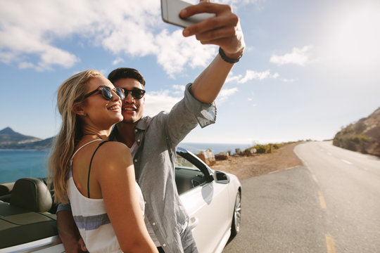 Couple making selfie photo on road trip