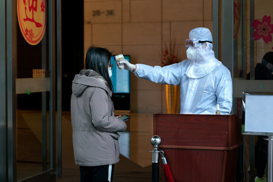 The body temperature check post on the entrance of business centre. Translation: The body temperature checkpost because of virus. Be aware