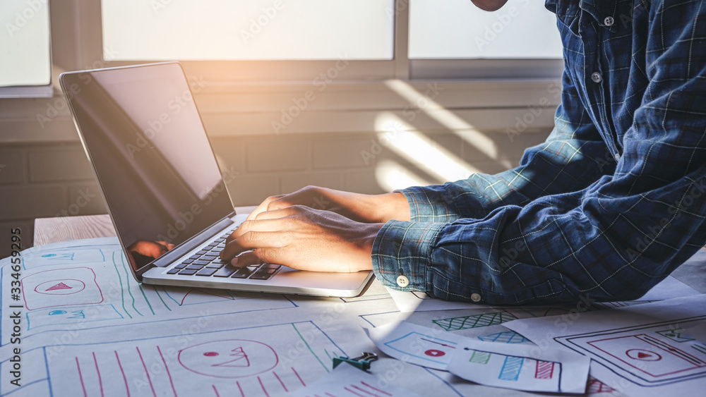 Poster close up male asian ui/ux designer working and designing a user interface for website and applicatio