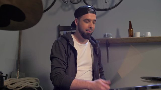 Guy rehearsing playing a drum kit