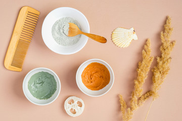 Cosmetic facial masks and SPA accessories on peach background. Natural SPA cosmetics for skincare, body and hair care concept. Flat lay, top view