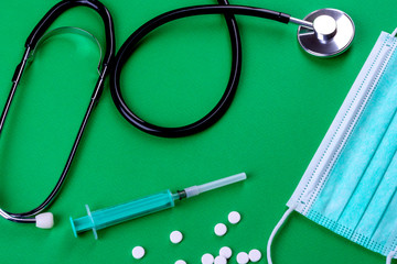 Medical supplies on a colored background as an attribute of the fight against coronavirus