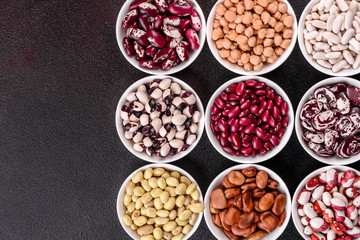 Pulses health food selection in white porcelain dishes over concrete background