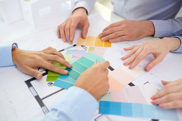 interior design, architecture and people concept - close up of designers team working with...