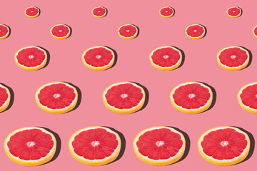 Fresh red orange or grapefruit on a peach color background.