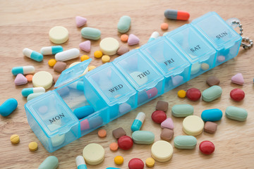 Top view of weekly pill box organizer, portable travel prescription or medication pill case on...