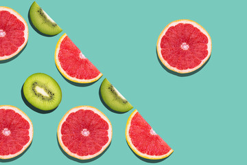 Seamless pattern with juicy kiwi and greapfruit on light blue background