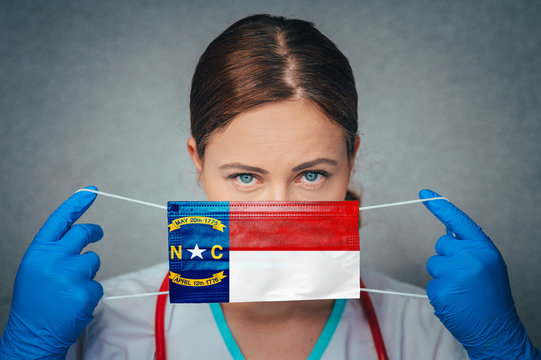 Coronavirus in U.S. State North Carolina, Female Doctor Portrait, protect Face surgical medical mask with North Carolina Flag. Illness, Virus Covid-19 in North Carolina