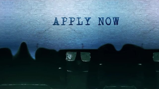 Apply Now Word closeup Being Typing and Centered on a Sheet of paper on old vintage Typewriter mechanical 4k Footage Background Animation.