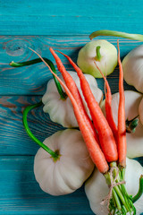 Vegetable set: carrots, patisons with green tails and multi-colored zucchini lie on an old wooden table