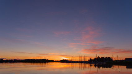 Fototapeta na wymiar Beautiful view of sunset, boats docking at wharf