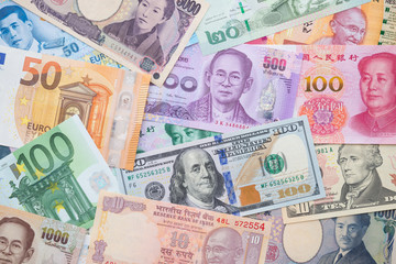 Fototapeta na wymiar Flat lay or top view of world international banknotes vary countries background. US Dollar, Chinese yuan, Japanese yen, Euro, Indian rupee, Thai baht. Concept of Forex or global financial economic.