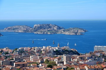 Fototapeta na wymiar Aerial panoramic view of beautiful Marseille, France under blue sky; small island and city on the sea