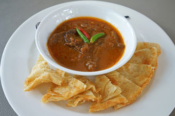Close up Stewed beef curry served with crispy Roti