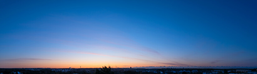 Panorama view of sky over city at sunrise with the blue background