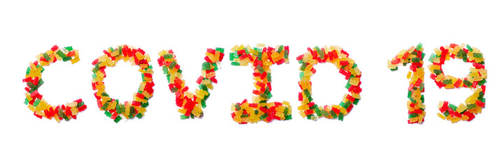 Inscription Covid 19 of the English alphabet  from multi-colored chewing marmalade on a white isolated background.Meal and medical  pattern.Sign  coronavirus from a photo of children's candy