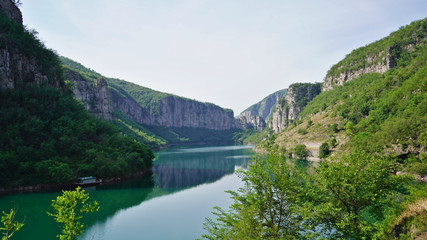 A sunny day in summer, landscape of beautiful lake and green mountains 