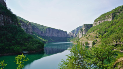 Fototapeta na wymiar A sunny day in summer, landscape of beautiful lake and green mountains 