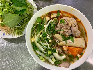 Vietnamese Hue city traditional beef rice noodle soup bow pork foot with vegetable