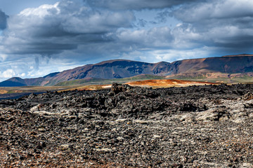 Beautiful colourful Icelandic landscape lava fields mountain geysers zigzag road and moss-covered...
