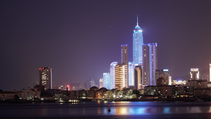 Obraz premium City night scenery. Reflection of Skyscrapers on water, China