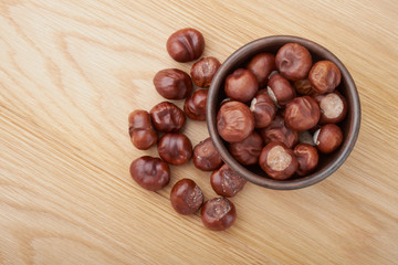 Chestnuts. Buckeye. Autumn mood. Sweet chestnuts on a wooden background.