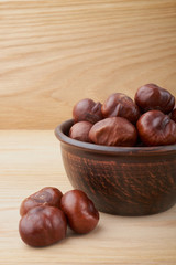 Chestnuts. Buckeye. Autumn mood. Sweet chestnuts on a wooden background.