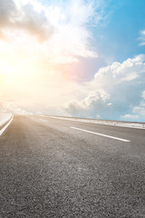 Asphalt highway road and sky sunset clouds landscape.