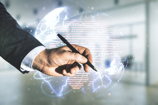 Double exposure of man hand with pen working with abstract digital world map hologram with connections on blurred office background, big data and blockchain concept