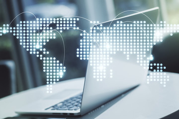 Abstract creative world map with connections on modern laptop background, international trading concept. Multiexposure