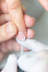 Close-up shot of a woman in manicure. Woman gets a manicure for nails