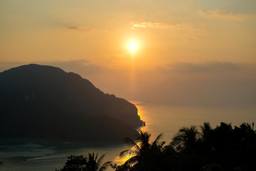 Fototapeta na wymiar Ocean in the rays of the setting sun. Paradise island at sunset.