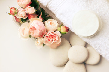  Spa background  with fresh roses, top view, pastel toned. Flowers, stones, white towel, relaxing set. 