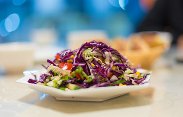 cabbage-based vegetable salad on a table in a restaurant