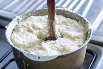 Ghomi, popular dish made of white coarse cornmeal, in big kettle.