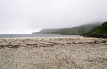 Landscape view of Calgary beach seen from the dirt natural path in Mull island, one of the main of the inner Hebrides in Scotland. It was a foggy summer day and the atmosphere was quiet and wet