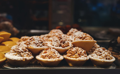 Desserts and sweets, baskets with nuts and cream in a window of a pastry shop
