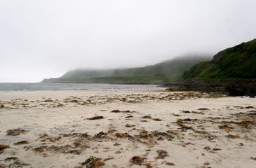 Landscape view of Calgary beach seen from the dirt natural path in Mull island, one of the main of the inner Hebrides in Scotland. It was a foggy summer day and the atmosphere was quiet and wet