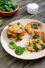 Pancakes with cabbage and spinach. Juicy vegetable cutlets on a plate with sour cream. Diet menu. Lenten dish.