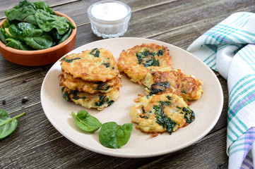 Pancakes with cabbage and spinach. Juicy vegetable cutlets on a plate with sour cream. Diet menu. Lenten dish.