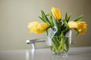 Fresh yellow tulips bouquet over wooden table. Isolated on white