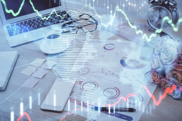 Stock market chart hologram drawn on personal computer background. Multi exposure. Concept of investment.