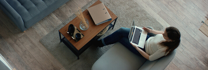 OVERHEAD Caucasian female working from home, having a video call with colleagues. Stay home, quarantine remote work