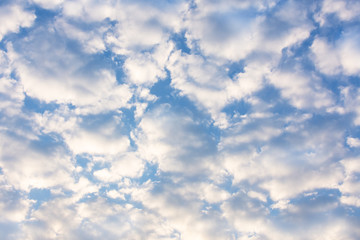 Blue sky with fluffy white clouds texture.