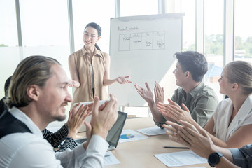 Attractive young asian business woman success explaning to her coworker team in meeting conference at modern office,Presentor female explain strategy plan to company partner with happy face and smile.