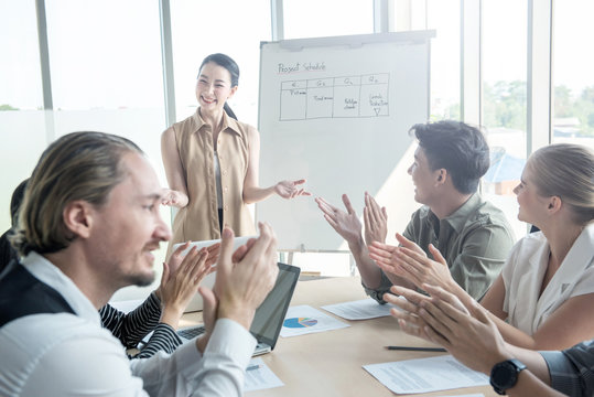 Attractive young asian business woman success explaning to her coworker team in meeting conference at modern office,Presentor female explain strategy plan to company partner with happy face and smile.
