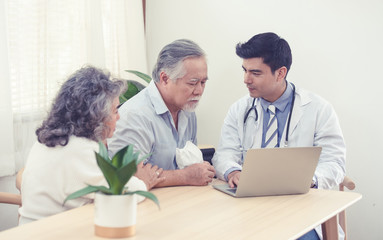 Obraz premium Elder senior old asian couple meeting specialist professional caucasian doctor visit at home consultant two retirement patient after checkup,health care and medical concept.