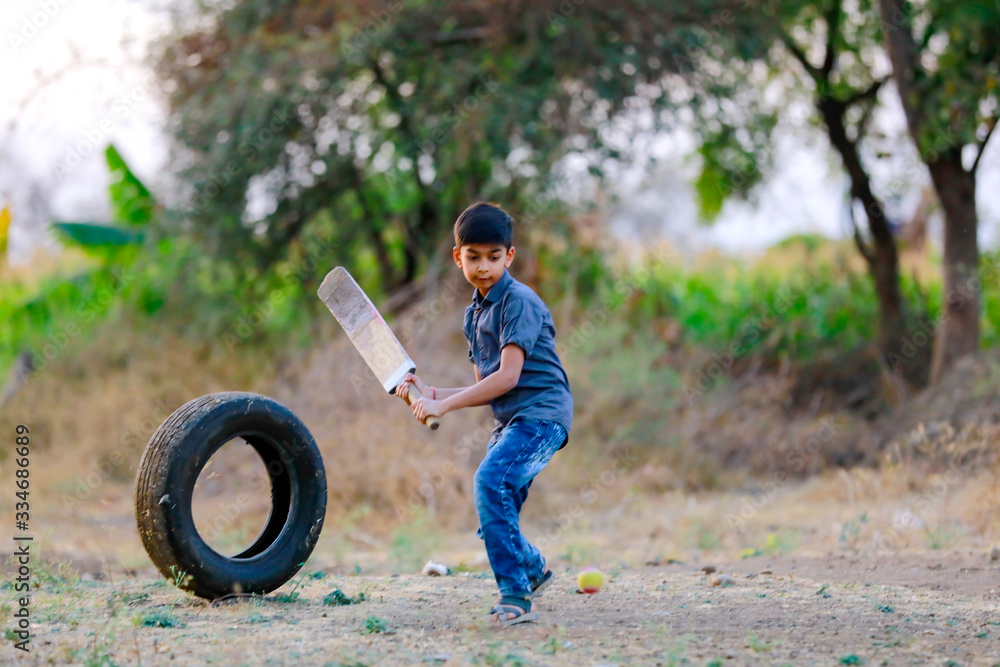 Wall mural Rural Indian Child Playing Cricket